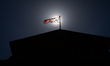 The Texas flag flies above the Texas State Capitol building in Austin, Texas on March 24,...