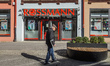 Elderly man walking with a crutch in front of the Rossmann store is seen on 2 April 2023 i...