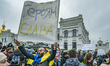 A protester holds a banner with the sentence ''glory to the heroes'' in a protest in the e...