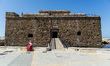 A tourist captures the area with her cell phone in front of the old castle in Paphos, Cypr...