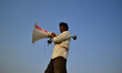 An indian electrician carry a loudspeaker to fix on a poll for upcoming Magh mela festival...