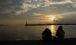 People admire a sunset near the Thessaloniki harbour.Thessaloniki, Macedonia region, Gree...