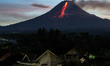 Mount Merapi, a volcanic mountain spews volcanic material as it erupts several times durin...