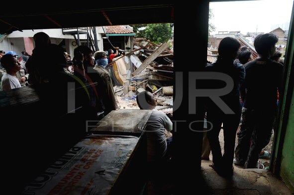 An Excavator Demolishing A House In A Slum Area In Jakarta