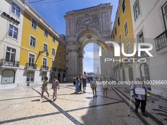 People are seen walking near the Augusta arch in Praca de Comercio, in the Baixa neighborhood, Lisbon. 02 May 2023. (