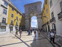 People are seen walking near the Augusta arch in Praca de Comercio, in the Baixa neighborhood, Lisbon. 02 May 2023. (