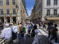 People are seen walking along one of the streets in the neighborhood of Baixa, Lisbon. 02 May 2023.  (