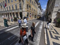 People are seen walking along one of the streets in the neighborhood of Baixa, Lisbon. 02 May 2023.  (