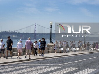 Several people are seen walking near the Tejo river bank, in the Baixa neighborhood, Lisbon. 02 May 2023. (