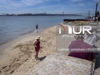 Several people are seen resting near a beach on the Tejo river, in the Baixa neighborhood, Lisbon. 02 May 2023. (