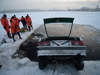 Rescuers of the Russian Service Emergency Situations Ministry perform a rescue during exercises on the frozen Neva River in St. Petersburg,...
