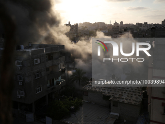 A picture shows a house being hit by an Israeli air strike in Gaza city on May 13, 2023. Israeli air strikes battered Gaza and militants fir...