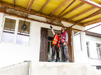 Volunteers from Gurtum foundation works in the school which their NGO reconstructs after the building was damaged by at least 3 bombs in Hos...