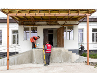 Volunteers from Gurtum foundation works in the school which their NGO reconstructs after the building was damaged by at least 3 bombs in Hos...