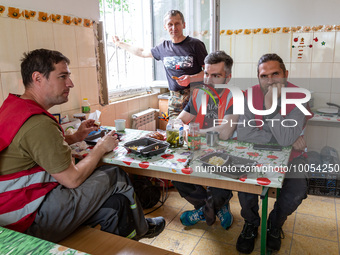 Volunteers from Gurtum foundation rest in the school which their NGO reconstructs after the building was damaged by at least 3 bombs in Host...