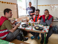 Volunteers from Gurtum foundation rest in the school which their NGO reconstructs after the building was damaged by at least 3 bombs in Host...