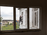 A volunteer from Gurtum foundation works in the school which his NGO reconstructs after the building was damaged by at least 3 bombs in Host...