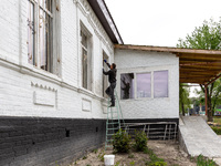 A volunteer from Gurtum foundation works in the school which his NGO reconstructs after the building was damaged by at least 3 bombs in Host...