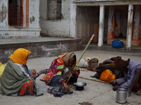 Indian saints cook their food over fire during a cold and foggy day in Allahabad on January 18,2016. A cold wave over northern India has bro...