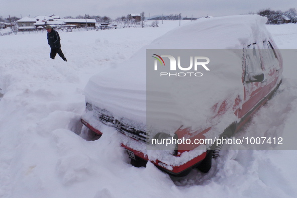 People try to shovel the snow from their cars as another try to pass snow blocked streets near the village of Yastrebino east of Bulgarian c...