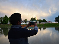People click pictures of Rainbow after heavy rainfall in Srinagar, Indian Administered Kashmir on 25 May 2023. Rainfall will continue in the...