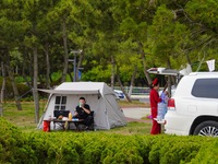 Tourists relax at a campsite in Yantai, Shandong province, China, May 7, 2023. According to the 2022-2023 China Camping Industry Research an...