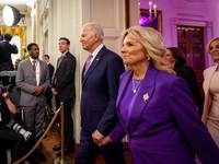 President Joe Biden and First Lady Dr. Jill Biden enter the White House East Room to host a ceremony celebrating the Louisiana State Univers...