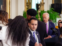 President Joe Biden watches with an obvious look over concern on his face, as aides tend to a Louisiana State University’s 2023 NCAA Champio...