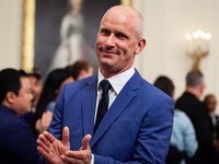 University of Connecticut men’s basketball team Head Coach Dan Hurley applauds his players as they leave a White House event celebrating the...