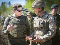 Estonian Minister of Defence Hanno Pevkur is seen speaking to a British Army commander near Tapa, Estonia on 20 May, 2023. Estonia is hostin...