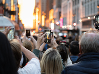 New Yorkers gather in Midtown on May 29th, 2023 to catch a glimpse of the 2023 Manhattanhenge, where the streets align perfectly with the se...