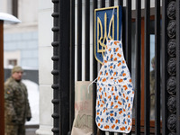 An women's apron hanging on the fence of the Defense Ministry,during a protest women for the equal rights with men to serve in the army,in K...
