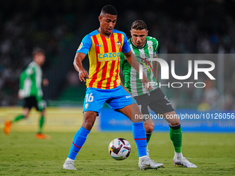 Samuel Lino of Valencia CF competes for the ball with Joaquin Sanchez of Real Betis during the LaLiga Santander match between Real Betis and...