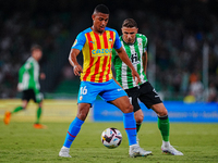 Samuel Lino of Valencia CF competes for the ball with Joaquin Sanchez of Real Betis during the LaLiga Santander match between Real Betis and...