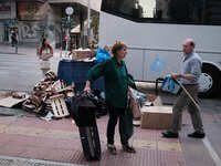 A woman with suitcases is looking for bus in Athens, Greece on June 5, 2023. (