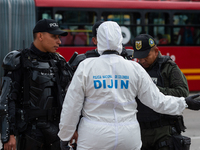 

Colombia's forensic police (DIJIN) and Anti-explosive police officers are recovering evidence after clashes between demonstrators and Colo...