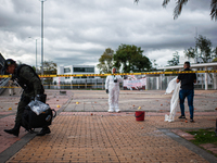 

Colombia's forensic police (DIJIN) and Anti-explosive police officers are recovering evidence after clashes between demonstrators and Colo...