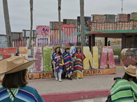

Chinese tourists are dressing in traditional Mexican costume at the site of the US-Mexico border construction in Playas de Tijuana, Mexico...