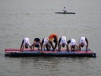 Participants perform yoga on the surface Yamuna River to mark the International Yoga Day celebrations on June 21, 2023 in New Delhi, India....