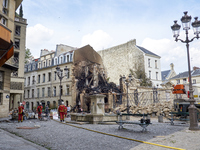 Firemen working on destruction and rubble in the aftermath of an explosion in a building on Rue Saint-Jacques near Place Alphonse-Laveran in...