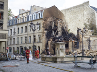 Firemen working on destruction and rubble in the aftermath of an explosion in a building on Rue Saint-Jacques near Place Alphonse-Laveran in...