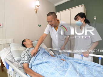 GUIYANG, CHINA - AUGUST 15, 2023 - Doctor Ni Pingbo (center) asks a patient about his recovery in Guiyang, Guizhou province, China, Aug 15,...