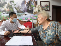 GUIYANG, CHINA - AUGUST 15, 2023 - Doctor Nie Mingzheng measures people's blood pressure in Guiyang, Guizhou province, China, Aug 15, 2023....