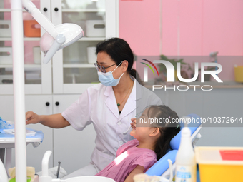 GUIYANG, CHINA - AUGUST 15, 2023 - Pediatric dentist Fang Yiping checks a child for dental caries in Guiyang, Guizhou province, China, Aug....