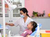 GUIYANG, CHINA - AUGUST 15, 2023 - Pediatric dentist Fang Yiping checks a child for dental caries in Guiyang, Guizhou province, China, Aug....