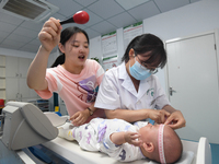 GUIYANG, CHINA - AUGUST 15, 2023 - Pediatrician Su Juan gives a baby a child health checkup in Guiyang, Guizhou province, China, August 15,...