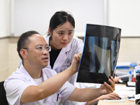 GUIYANG, CHINA - AUGUST 15, 2023 - Wang Lei (L), director of the Department of Bone Surgery at the People's Hospital, works on a clinical di...