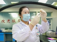 TENGZHOU, CHINA - AUGUST 17, 2023 - A nurse checks a blood sample at a laboratory in Tengzhou city, Shandong province, China, August 17, 202...