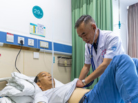 Gastroenterologist Tian Chuanzai examines a patient in Chongqing, China, August 18, 2023. August 19th is the Chinese Doctor's Day. (