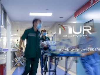 Emergency department doctor Luo Pengyu (left) escorts an emergency patient into the emergency room in Chongqing, China, August 18, 2023. Aug...